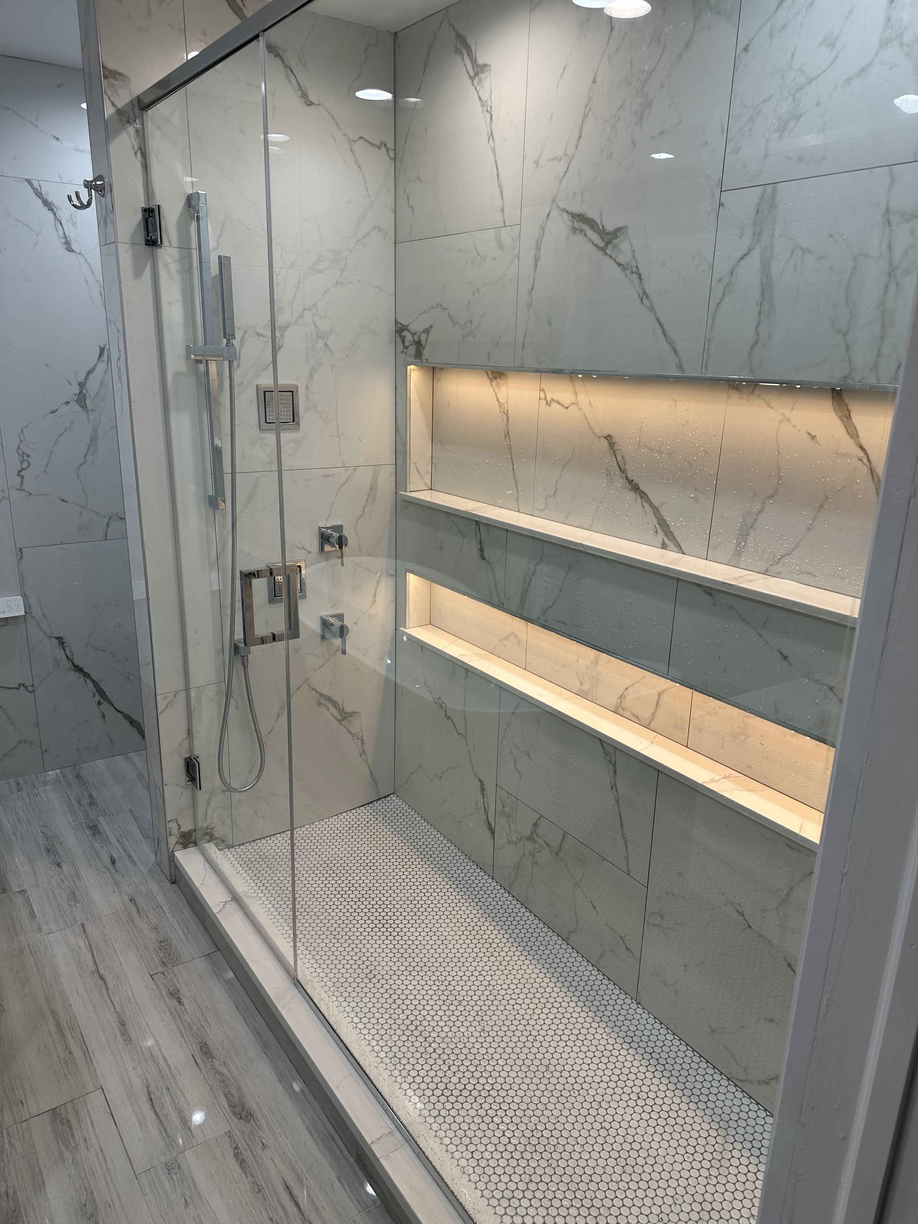 Custom walk-in shower with illuminated niches